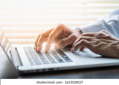 Businessman typing on laptop keyboard and another hand on touchpad. Business concept.