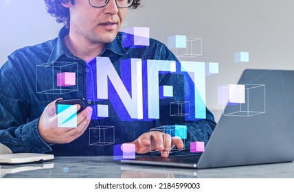 Businessman typing on laptop, using smartphone. Digital hologram of NFT, data blocks and virtual art. Concept of blockchain and cryptoart