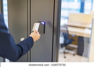 Businessman Unlocking Door With Card Key