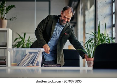 Businessman Unpack His Plastic Box With Belongings After He Return To Work In The Office