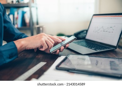 Businessman Use Cell Phone And Working On Office Desk And Analyzing New Project Of Accounting Finance. Investment, Financial Advisor And Accounting Concept.