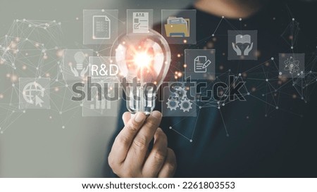  Businessman use a computer with the R and D icon for Research and Development on the laptop screen. RD. Research and Development Business Science Technology Concept. Manage costs more efficiently. Stock fotó © 
