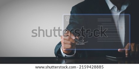 businessman use electronic pen sign signature on electronic  E-signing, data sheet document management, paperless office concept. Businessman using stylus pen signing e document on digital tablet.
