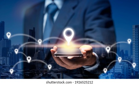 Businessman use internet network on mobile phone find location in the city by GPS Navigator Map. Man hold smart Phone connect to GPS location icon show global business, direction, travel, 5G concept.