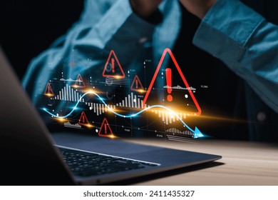 Businessman use laptop with virtual world economic growth chart with red warning sign for caution in investing economic situation warning, Business investment risks. - Powered by Shutterstock - Get 15% off with code: PIKWIZARD15