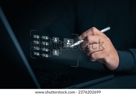 Businessman use a pen to draw organization chart, mind map, or organigram on a virtual screen. HR Manager works on HR company structure tree diagram, resource leveling, and career path concepts.