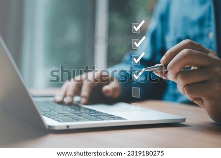 Businessman use pen to tick correct sign mark in checkbox for quality document control checklist and business approve project concept.