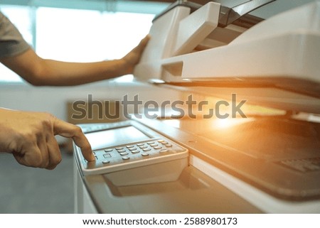 Businessman use photocopy or copier or photocopier in office workplace is equipment for copy duplicate Xerox or scanner to scanning document or printer for printing paper.
