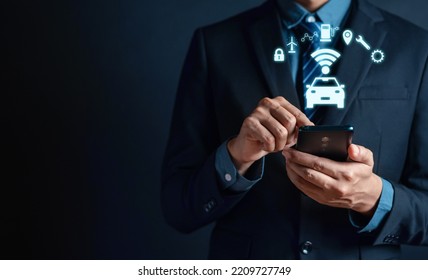 Businessman use smartphone control Intelligent car app eco system vehicle and smart cars with showing icon of the car and information about parking location, fuel, energy saving, service and security. - Powered by Shutterstock