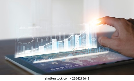 Businessman use tablet analysis graph for trade stock market on the screen Businessman hands use tablet check chart stock growth. Hand male stock graph chart point target success