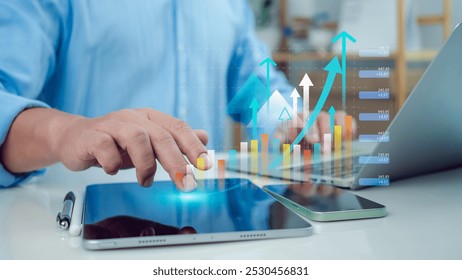 Businessman use tablet showing a growing virtual hologram of analytics dashboard with charts, Stock market, Business growth, Progress or success concept, Invest in trading, Finance, Sales, Marketing. - Powered by Shutterstock