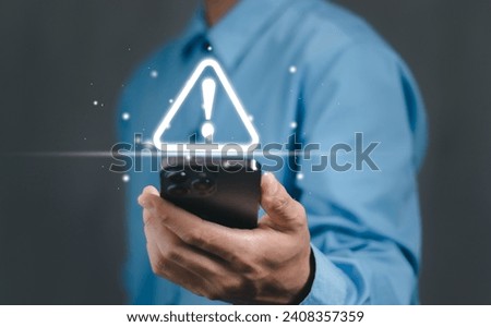Businessman or User, programmer, developer using smart phone with triangle caution warning sign for notification error and maintenance warning and safety concept.