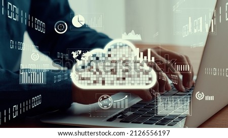 Businessman uses capable laptop computer to connect to cloud computing network for team data sharing on the cloud server and access computer files