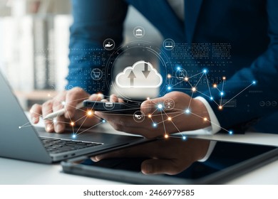 Businessman uses cloud computing technology through laptop and tablet. Data backup and storage in online cloud, network storage Smart business in the future.