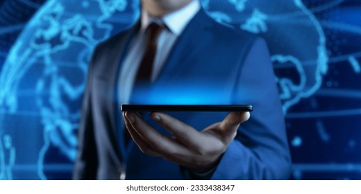 Businessman uses a smartphone. Internet technology and business concept. Empty space. Template for text - Shutterstock ID 2333438347