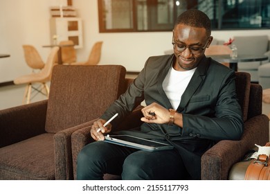 Businessman Uses Smartphone Waiting For A Flight, Traveling Entrepreneur Remote Work Online Sitting In A Boarding Lounge Of Airline Hub.