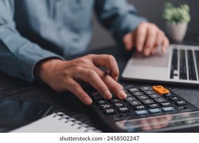 Businessman using calculator bookkeeping payroll and budget tax. Business document finance accounting investment  - Powered by Shutterstock