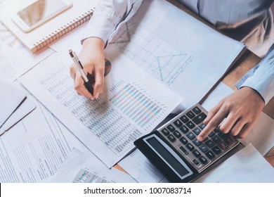 businessman using calculator for calculate budget. concept finance and accounting - Shutterstock ID 1007083714