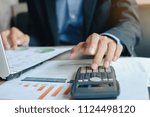 Businessman using calcultor for analysis maketing plan, Manager calculate financial report and graph chart.   