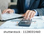 Businessman using calcultor for analysis maketing plan, Manager calculate financial report and graph chart.  Business, Finance and Accounting concepts