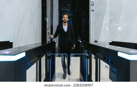 Businessman using card to open automatic gate machine in office building. Male using smart card to open automatic gate machine in office building. Working routine concept. - Shutterstock ID 2283258907