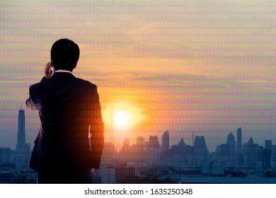 Businessman using cellphone on sunrise at digital city background, Digital smart city or business disruption concept
