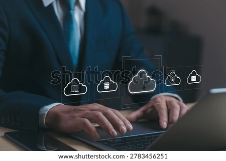 Businessman using cloud computing interface on laptop computer for data storage, concepts of cybersecurity ,data backup, data center providers, enterprise technology and digital network management.