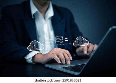Businessman using cloud computing technology for data transfer and storage. Concept of cloud computing, data security, online storage, network infrastructure, and digital transformation in business.