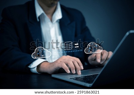 Businessman using cloud computing technology for data transfer and storage. Concept of cloud computing, data security, online storage, network infrastructure, and digital transformation in business.