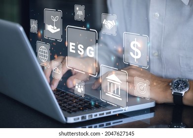 Businessman using a computer for analysis ESG environmental social governance business strategy investing concept. - Shutterstock ID 2047627145