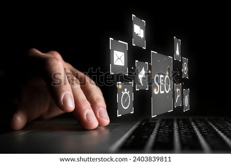 A businessman is using a computer to analyze SEO search engine optimization marketing data, digital marketing image