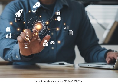 Businessman using a computer to AR virtual screen dashboard with project management with icons of scheduling, budgeting, communication. - Shutterstock ID 2165473737