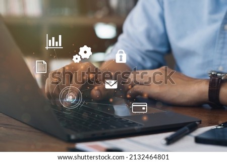Businessman using a computer to AR virtual screen dashboard with project management with icons of scheduling, budgeting, communication.
