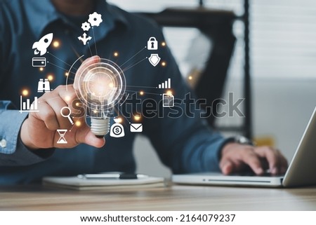 Businessman using a computer to AR virtual screen dashboard with project management with icons of scheduling, budgeting, communication.