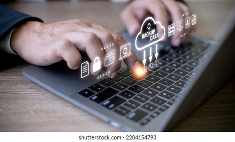 Businessman using a computer to backup storage data Internet technology concept for backup online documentation database and digital file storage system or software,file access, doc sharing. - Shutterstock ID 2204154793