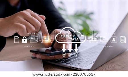 Businessman using a computer to backup storage data Internet technology concept for backup online documentation database and digital file storage system or software,file access, doc sharing.