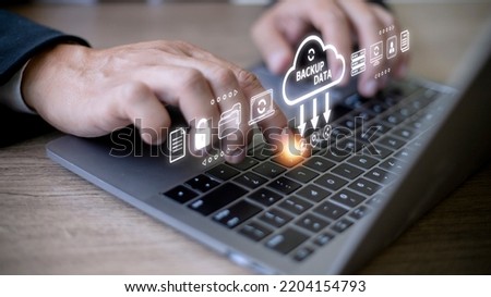 Businessman using a computer to backup storage data Internet technology concept for backup online documentation database and digital file storage system or software,file access, doc sharing. Foto stock © 