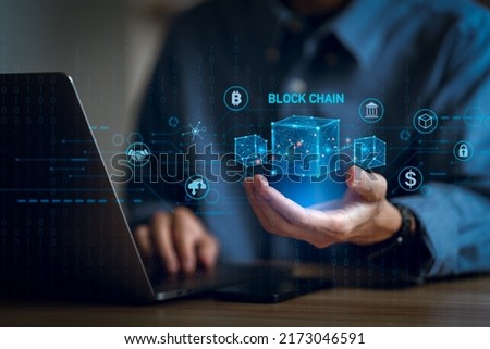 Businessman using a computer and blockchain icon in hand  to Blockchain technology concept with a chain of encrypted blocks to secure cryptocurrencies and bitcoin for online payments 
