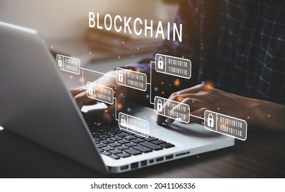 Businessman using a computer to Blockchain technology concept with a chain of encrypted blocks to secure cryptocurrencies and bitcoin for online payments and money transaction - Shutterstock ID 2041106336