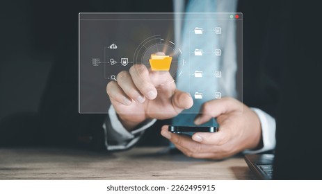 businessman using a computer Cloud technology and Data storage on smartphone and laptop. data Internet technology. backup online database and digital file storage system, file access, doc sharing.