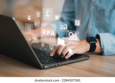 Businessman using a computer and dashboard RPA for robots, process automatic banner web icons for business process optimization innovation technology concept.
