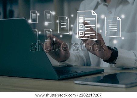 Businessman using a computer to document management concept, online documentation database and digital file storage system software, records keeping, database technology, file access, doc sharing.