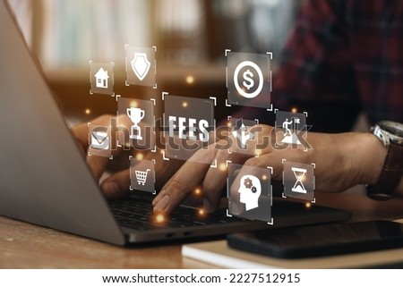 Businessman using a computer to Fees Financial Technology. Virtual screen of future and touches icon fees with dollar. Business hidden money, service fee and tax concept. 