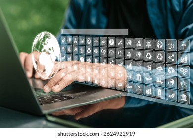 A businessman using a computer with a globe and various icons, representing environmental concepts, green business investment, environmental analysis, awareness, and a strong focus on climate change.