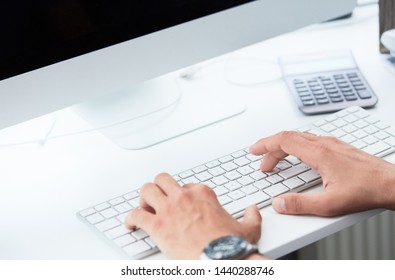 Businessman using computer keyboard close-up. Close up of male hands typing on computer keyboard. Blogger, journalist writing new article.