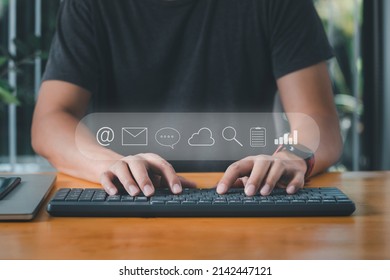 Businessman Using Computer Keyboard For Email, Instant Message, Cloud System, Search Data, Note Document And Business Graph Icons.