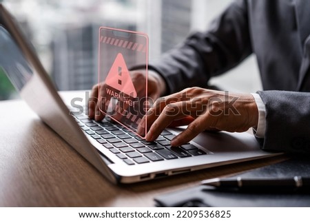 Businessman using computer laptop with caution warning sing for notification error and virus detection spyware, Internet network security concept