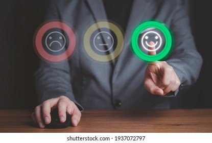 Businessman using computer mouse and pushing smile button for the best evaluation , customer satisfaction concept.