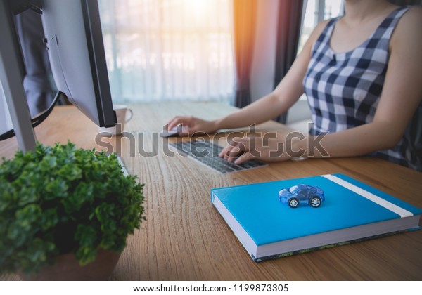 businessman using computer for rent, buy a\
car with online internet, side view on wood\
table.