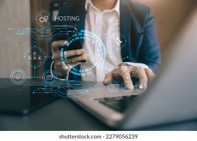 businessman using computer, smartphone and presses his finger on the virtual screen inscription Hosting on desk, Web hosting concept, Internet, business, digital technology concept.